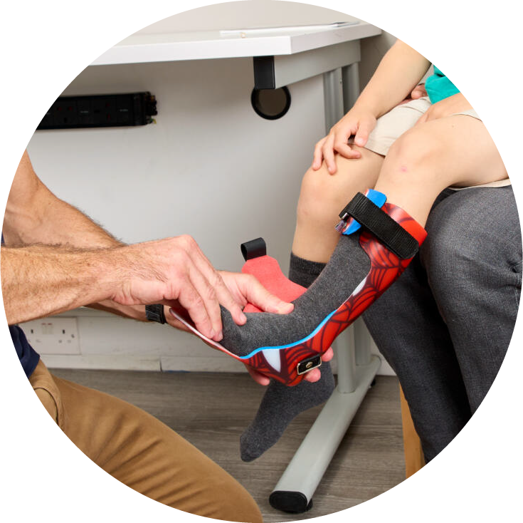 Clinician fitting custom AFO to child leg